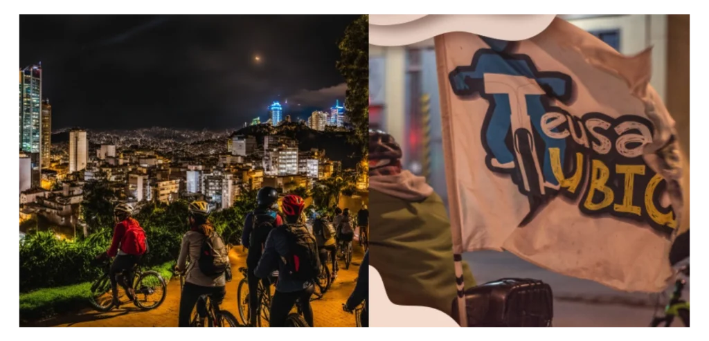 Grupo de ciclistas recorriendo Bogotá de noche, con vista panorámica de la ciudad iluminada y bandera del colectivo Teusaca tu bici.